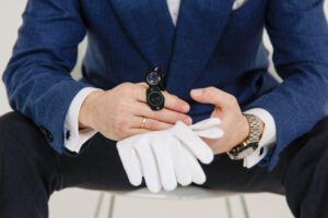 Man in blue suit jacket wearing black analog watch