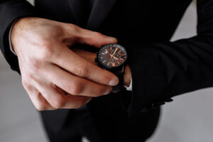 businessman looks at the watch on his wrist, looks at the time. High quality photo