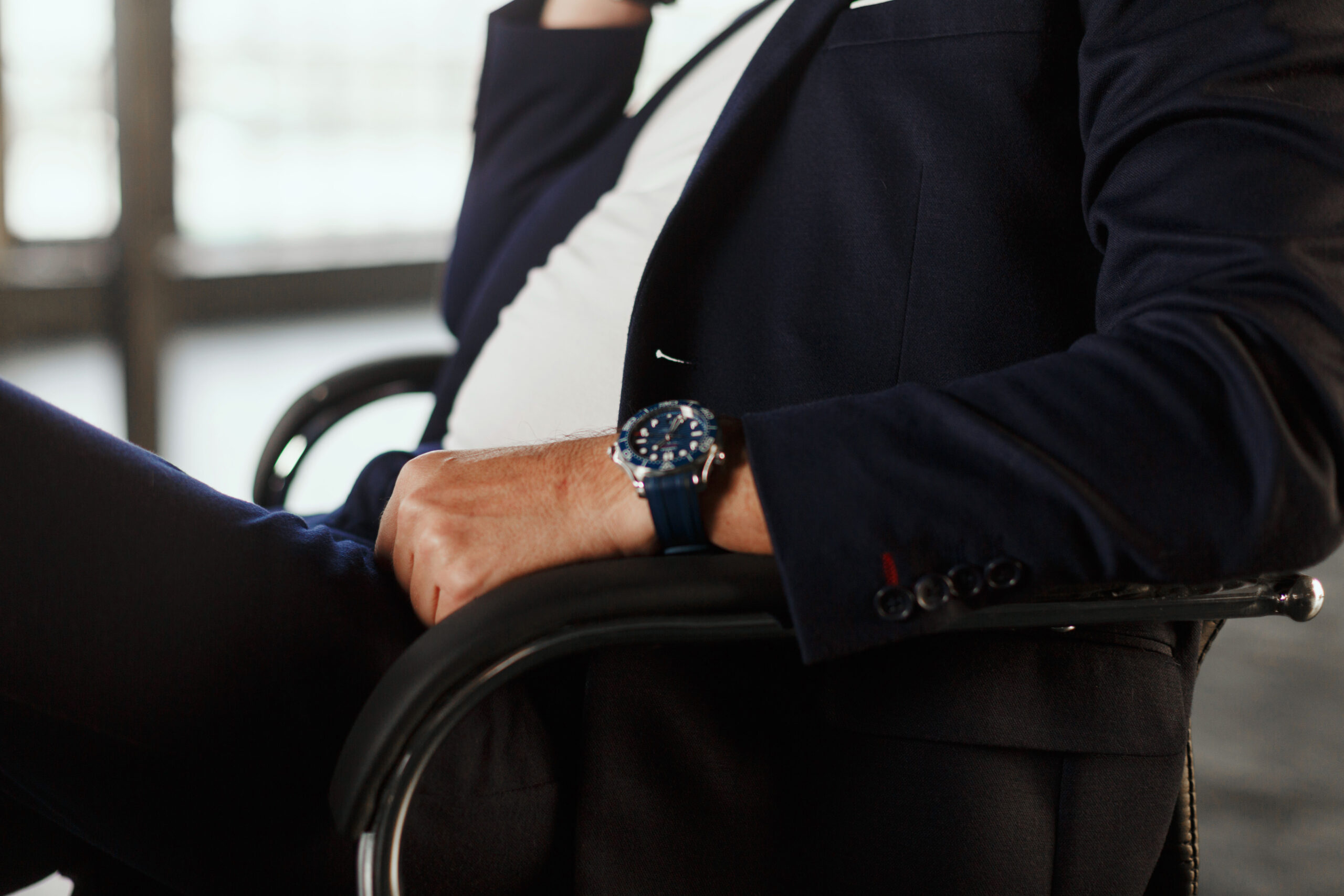 Person in black blazer sitting on a chair